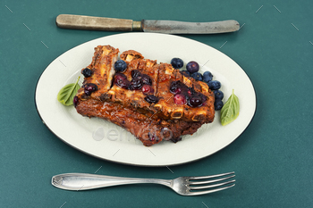 Grilled pork ribs with berry sauce.