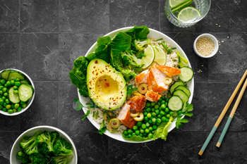 Salmon avocado bowl with broccoli, inexperienced peas, rice and sleek salad. Wholesome meals, prime query