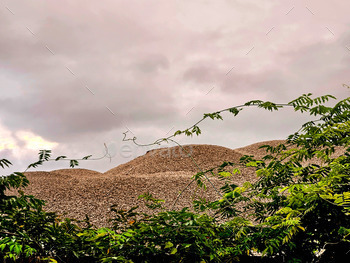 Mountain of gravel in a depart yard piquant for retail sale in constructing supplies.