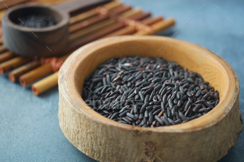 Shadowy Rice Grains in a wooden bowl .