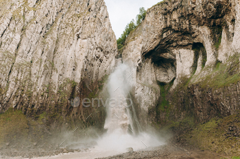 A excessive, stormy waterfall flowing down the broad rocks of Djily-su. A budge via the mountain