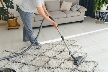 Lady with accumulator vacuum cleaner.