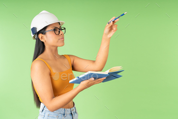 Architect with protective helmet working with notebook