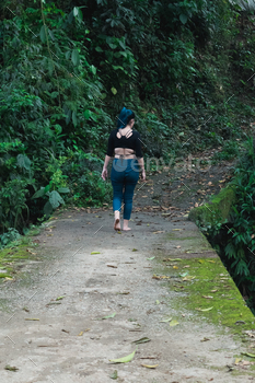 lady rock climbing barefoot. feeling free. young latina lady with blue hair, walking on a cement bridge