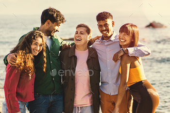 Diverse Chums Embracing and Walking by the Sea