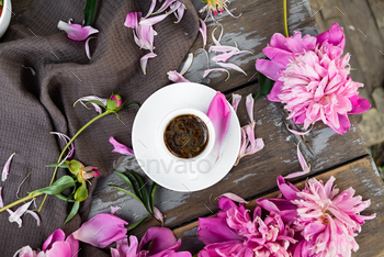 Nonetheless life with peonies and a coffee cup on a shadowy background. A present card. Wedding ceremony card.