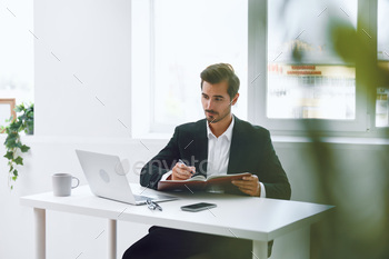 Man drained glasses sitting pc desk change hands thinking predicament of job working