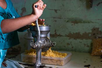 holding the cope with of the machine to grind corn to effect the dough former to effect passe arepas