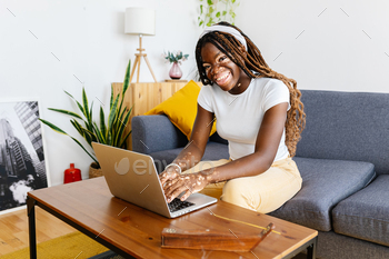 Younger african student lady studying on laptop laptop from house