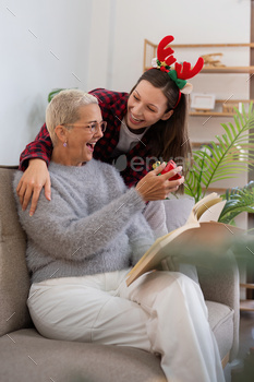 Merry Christmas senior woman with grownup daughter trade reward dwelling