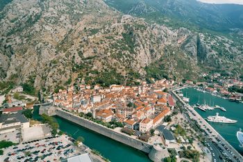 Fortress walls of the old city of Kotor on the shore of the bay. Montenegro. Drone