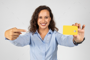 Particular young european businesswoman in formal wear point finger at bank card, be pleased purchasing