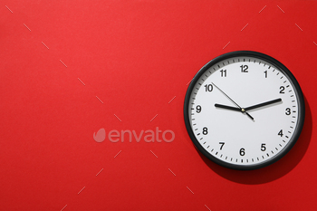 A spherical clock on a crimson background