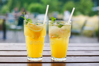 Trendy summer season season drinks with orange on the desk within the cafe