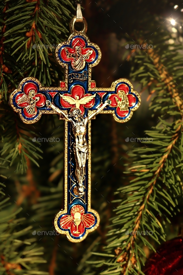 Actual christmas tree element with ornate dangerous of Jesus and purple ornament