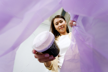 asian lady putting and sorting plastic espresso cup destroy to recycle bin POV.