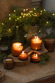 Soy candles burn in glass jars. The evening is darkish. Aromatherapy and leisure. Consolation at dwelling