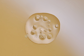 A drop of serum with bubbles on a beige nude background.