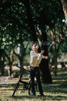 Cheerful energetic lady in as so much because the second attire with bicycle in park, Exterior portrait, Elegant lady enjoyi