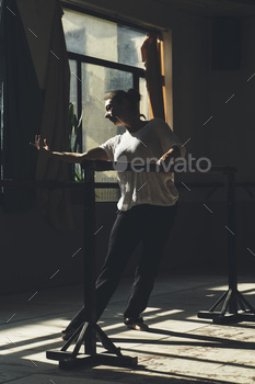 Ballet dancer practising indoors.