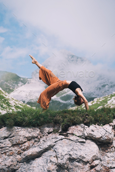 Yoga on nature. Youthful woman is practising yoga in mountains