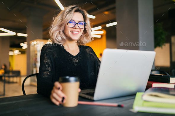 younger woman engaged on pocket book pc in co-working house of job