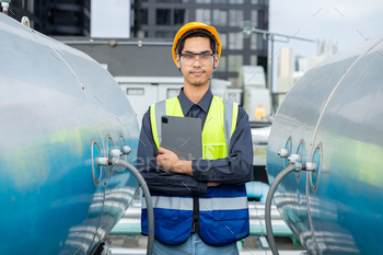 Engineer checks valves, water tanks, pumps and devices linked to scorching water manufacturing pipe