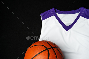 Discontinuance-Up of Basketball and White and Purple Jersey on a Unlit Background