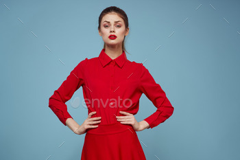 trendy lady in fascinating apparel on blue background gesturing with arms and purple lips make-up