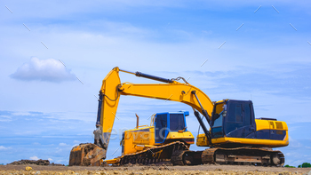 Excavator and dust grader are leveling the bottom for industrial manufacturing facility constructing nervousness rental