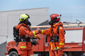 A unified workforce of firefighters, adorned of their uniforms, engages in a heartfelt procure collectively marked