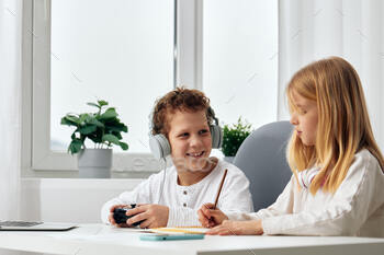 Totally overjoyed Children Taking half in On-line Video video games and Taking Selfies Collectively at Dwelling A brother and sister