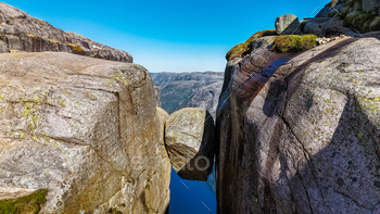 A discontinuance-up peep of an enormous, balanced rock formation in Norway.Kjeragbolten, Norway