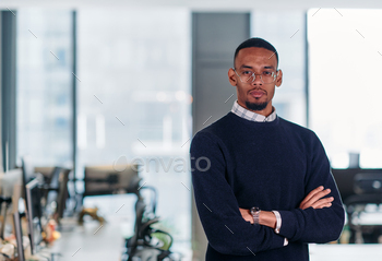 Assured African American Businessman Posing in Fashionable Startup Office.