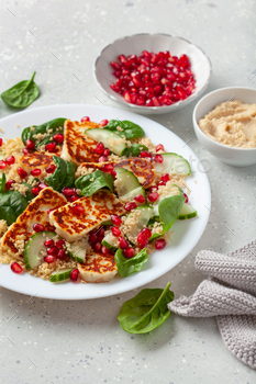 healthful halloumi cheese and couscous salad with cucumber spinach pomegranate hummus