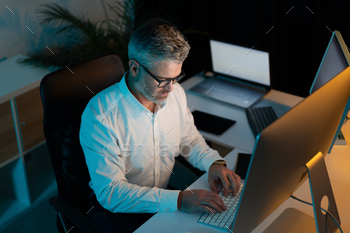 Focused Man Working Behind at House of job Utilizing Laptop and Laptop