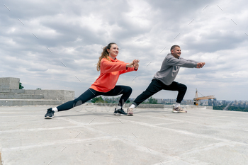 inside the park a youthful couple in admire doing sports activities actions {couples} warming up wholesome lifestyle synchronized