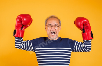 Portrait Asian inclined man sporting glasses do on two crimson boxing gloves studio shot remoted yellow