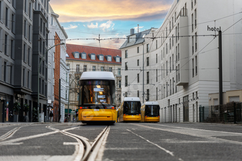 Scenic night watch many updated yellow tram car parked at avenue station Berlin Mitte central