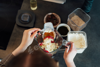 Shut up excessive respect woman together with plant principally principally based mostly fully pea protein powder proper by way of making smoothie on the kitchen