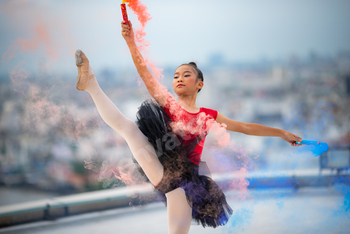 Lovable runt ballet dancer performing handstand posture whereas practising dance