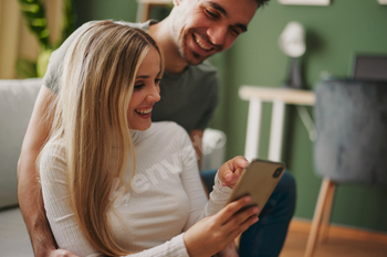 Pleasing younger totally happy couple on-line by technique of smartphone at dwelling