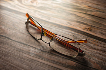 Former learning glasses mendacity on picket desk