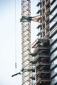 Building crane lifting provides beside excessive-upward thrust constructing.