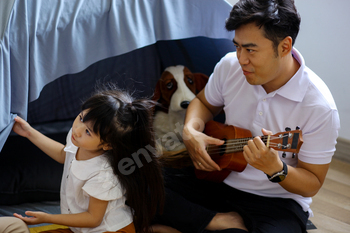 Asian Family Having Palatable Time Enjoying Instrument The utilization of Ukulele