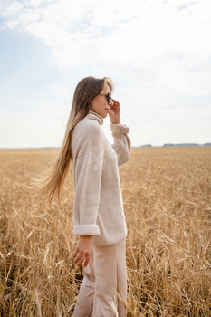 A Fashionable Girl is Collaborating in a Beautiful Sunny Day throughout the Middle of a Wheat Self-discipline