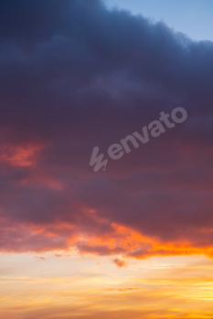 Vibrant sundown sky with dramatic clouds over mute horizon.