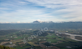 Scenic Aerial Ogle of Fraser Valley, BC, Canada with Mountains and Farmland Panorama