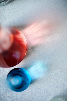 Excessive View of Delicate Reflection by design of Crimson and Blue Glass Beakers on Desk