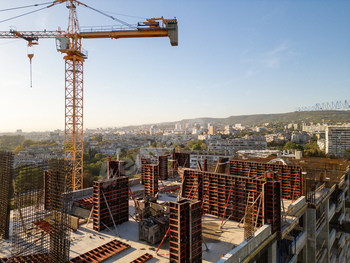 A drone video capturing the establishing state of affairs of a excessive-rise establishing at sundown. The construction’s